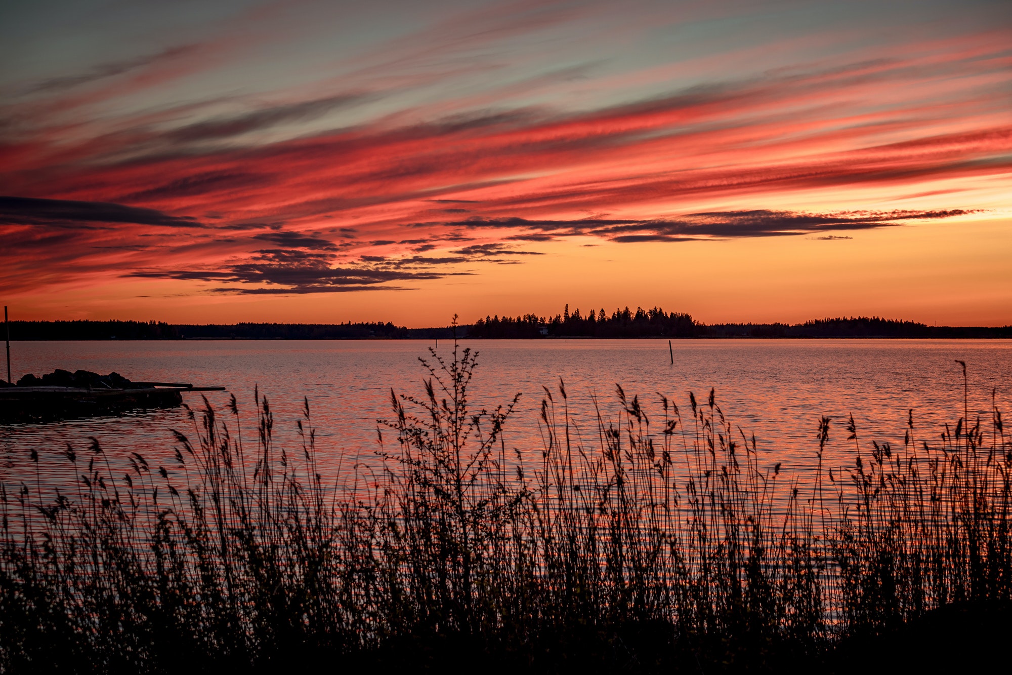 Crimson sunset on the background of the Gulf of Bothnia